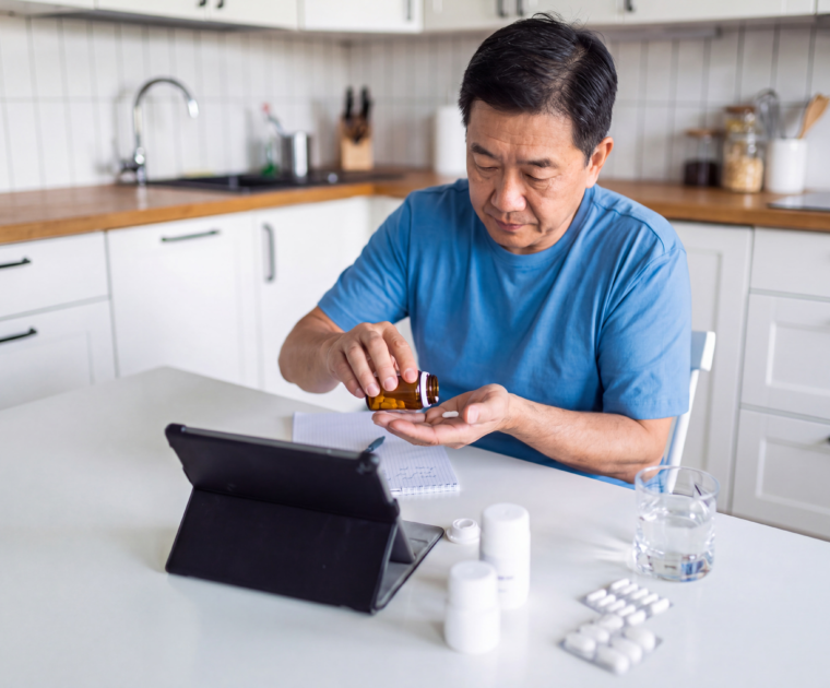 Man reviewing osteoporosis medicine before a dental surgery consultation