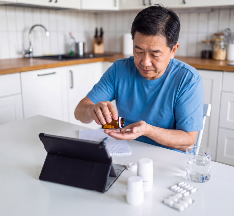 Man reviewing osteoporosis medicine before a dental surgery consultation