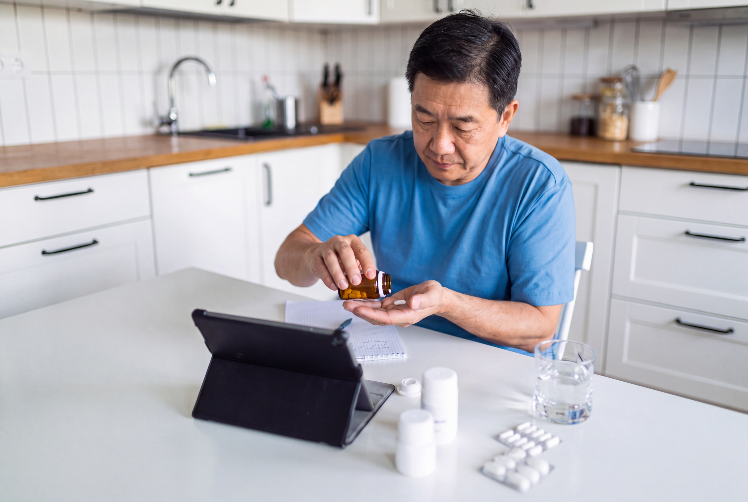 Man reviewing osteoporosis medicine before a dental surgery consultation
